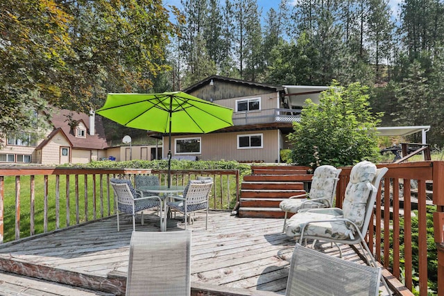 6519I Myrtle Dr, Nine Mile Falls, WA 99026 - wooden terrace with outdoor dining area and a lawn