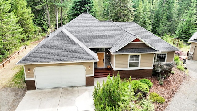 13306 N Muzzy Rd, Newman Lake, WA 99025 - view of front of house with roof with shingles, concrete driveway, a view of trees, an attached garage, and brick siding