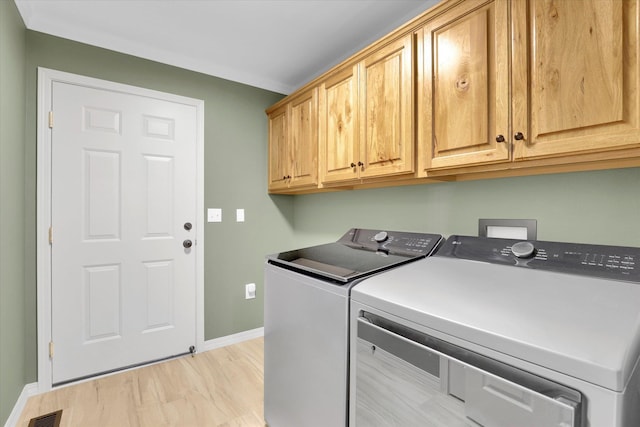 13306 N Muzzy Rd, Newman Lake, WA 99025 - laundry room with cabinet space, washer and clothes dryer, and light wood-style floors