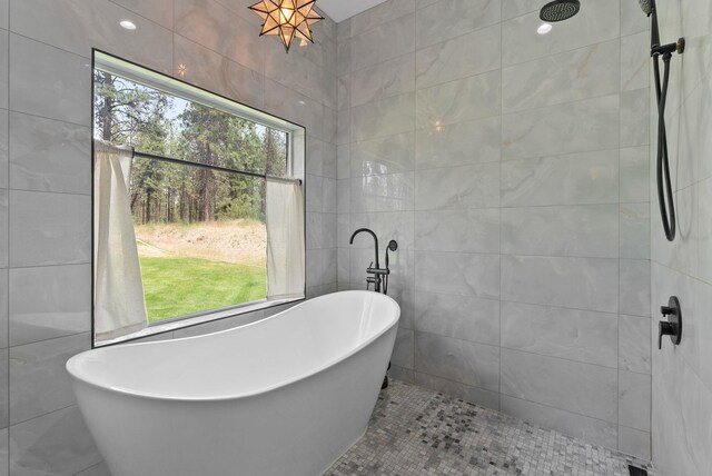 7617 S Cedar Rd, Spokane, WA 99224 - bathroom with tile walls, a soaking tub, tile patterned floors, and a tile shower