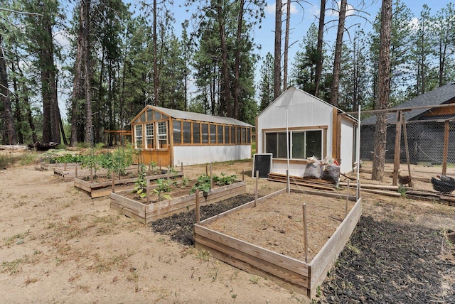 7617 S Cedar Rd, Spokane, WA 99224 - back of property featuring a vegetable garden, an outdoor structure, and an exterior structure
