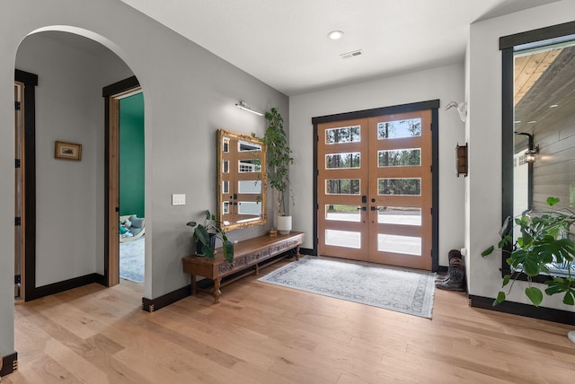 7617 S Cedar Rd, Spokane, WA 99224 - entryway with arched walkways, french doors, and light wood finished floors