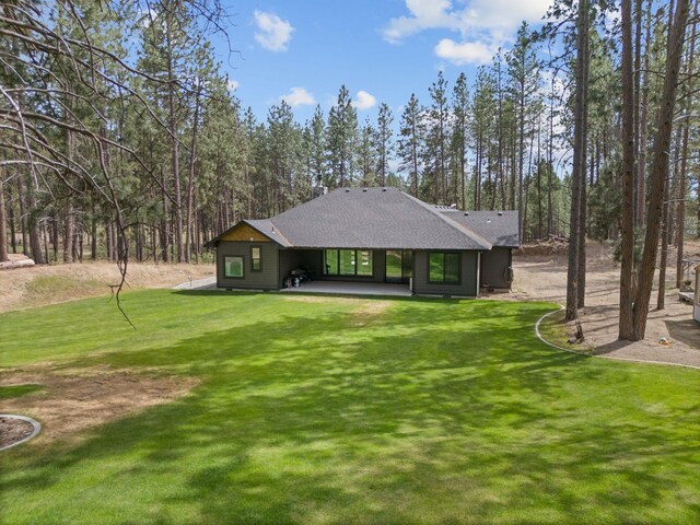 7617 S Cedar Rd, Spokane, WA 99224 - back of property with a yard, roof with shingles, and a patio area