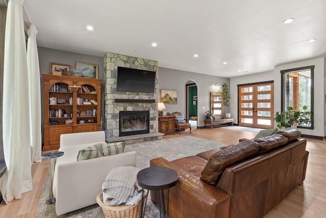 7617 S Cedar Rd, Spokane, WA 99224 - living area featuring arched walkways, a fireplace, light wood-style flooring, and recessed lighting