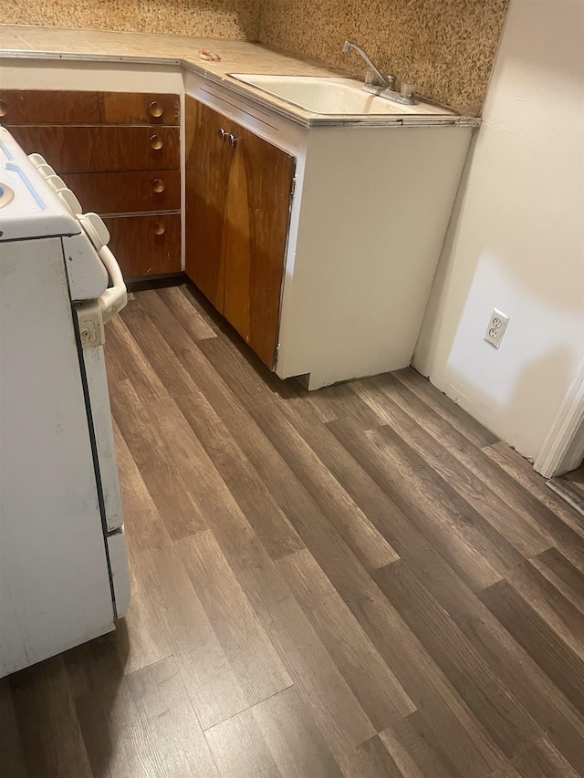 2613 W Gardner Ave, Spokane, WA 99201 - kitchen featuring range, dark wood finished floors, and brown cabinets