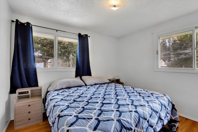 3511 W Francis Ave, Spokane, WA 99205 - bedroom with wood finished floors and a textured ceiling