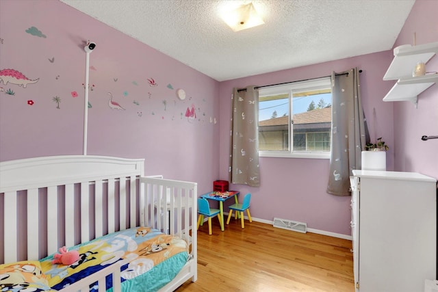 3511 W Francis Ave, Spokane, WA 99205 - bedroom with light wood finished floors and a textured ceiling
