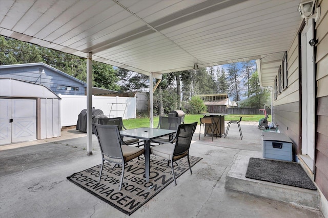 3511 W Francis Ave, Spokane, WA 99205 - fenced backyard with outdoor dining space, a storage shed, a grill, and a patio area