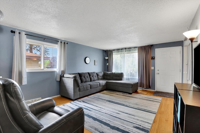 3511 W Francis Ave, Spokane, WA 99205 - living area with a textured ceiling and light wood-type flooring