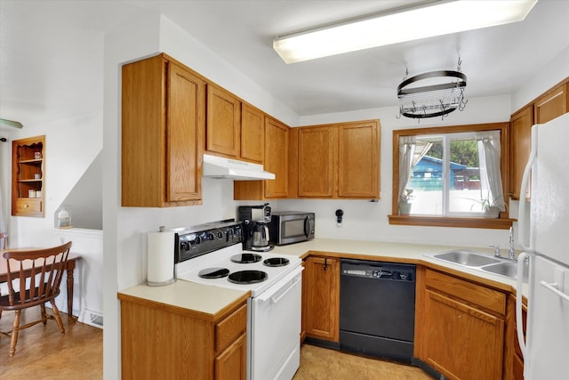 3511 W Francis Ave, Spokane, WA 99205 - kitchen featuring white appliances, under cabinet range hood, light countertops, and brown cabinetry