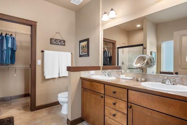 2820 S Galway Ln, Spokane Valley, WA 99037 - bathroom with double vanity, a spacious closet, a shower stall, and stone tile flooring