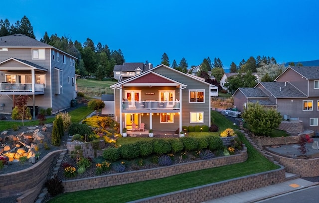 2820 S Galway Ln, Spokane Valley, WA 99037 - back of property at dusk featuring a balcony and a yard