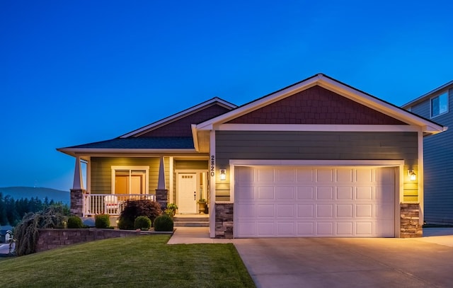 2820 S Galway Ln, Spokane Valley, WA 99037 - view of front of property with concrete driveway, a garage, stone siding, and a front yard