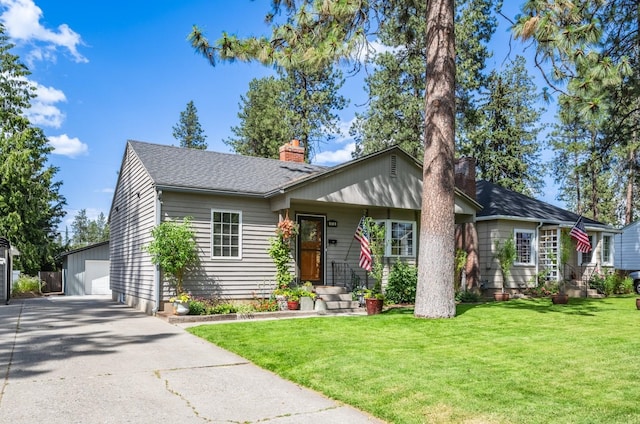 17 E 34th Ave, Spokane, WA 99203 - view of front facade with a chimney, a garage, an outbuilding, and a front lawn