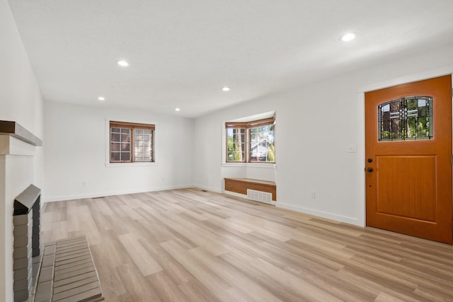 17 E 34th Ave, Spokane, WA 99203 - unfurnished living room with light wood-style flooring, recessed lighting, and a fireplace