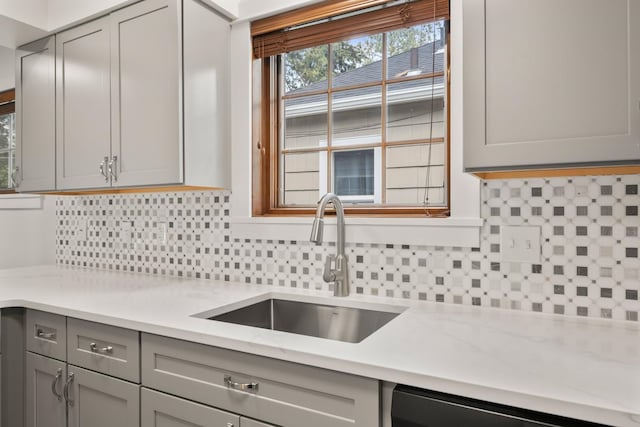 17 E 34th Ave, Spokane, WA 99203 - kitchen with gray cabinetry, backsplash, dishwasher, and light stone counters