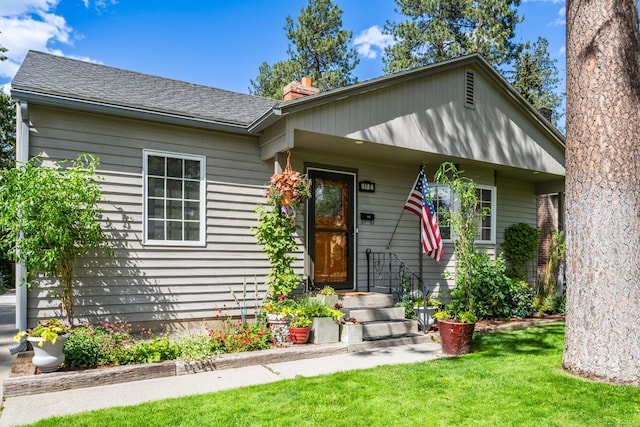 17 E 34th Ave, Spokane, WA 99203 - bungalow-style house with a front yard, a chimney, and a shingled roof