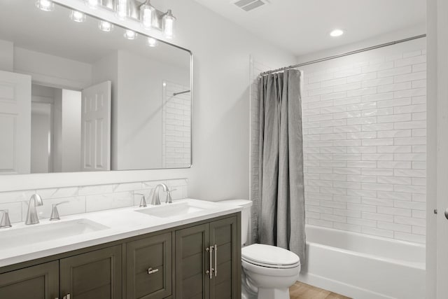 17 E 34th Ave, Spokane, WA 99203 - full bathroom featuring double vanity, shower / bath combo with shower curtain, and wood finished floors