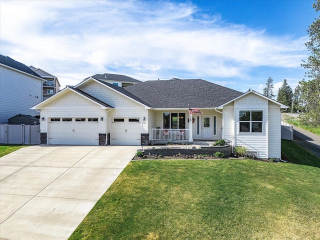 9302 W Floyd Dr, Cheney, WA 99004 - view of front of property with covered porch, an attached garage, concrete driveway, and stone siding