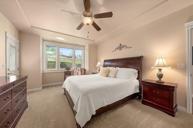 9302 W Floyd Dr, Cheney, WA 99004 - bedroom with light carpet, a ceiling fan, and a raised ceiling