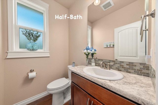 9302 W Floyd Dr, Cheney, WA 99004 - half bath with vanity, wood finished floors, and tasteful backsplash