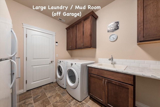 9302 W Floyd Dr, Cheney, WA 99004 - washroom featuring cabinet space, stone finish floors, and separate washer and dryer