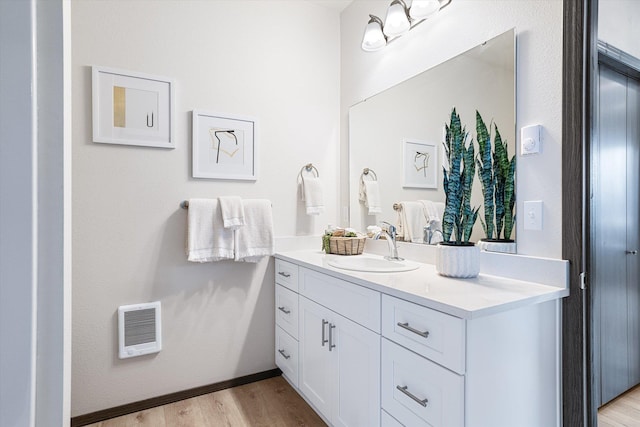 10718 E Augusta Rd, Spokane, WA 99207 - bathroom with vanity, wood finished floors, and heating unit