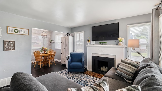4204 W Olympic Ave, Spokane, WA 99205 - living area with a chandelier, wood finished floors, and a fireplace
