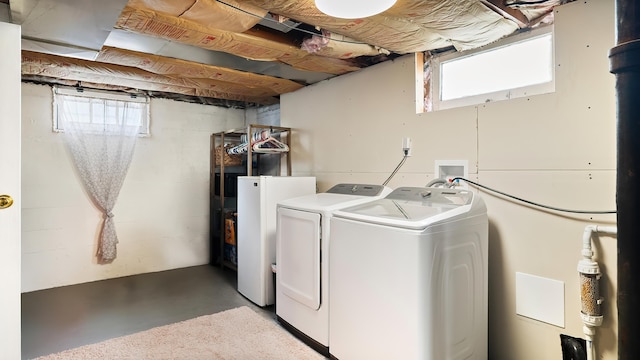 4204 W Olympic Ave, Spokane, WA 99205 - laundry area featuring washing machine and dryer, plenty of natural light, and concrete block wall