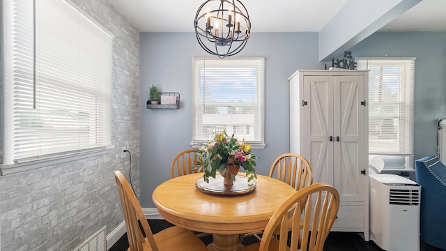 4204 W Olympic Ave, Spokane, WA 99205 - dining room featuring a chandelier and brick wall
