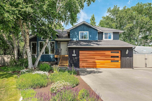 2913 E 61st Ct, Spokane, WA 99223 - view of front of home with an attached garage, a shingled roof, and driveway