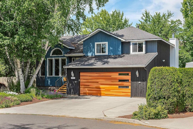 2913 E 61st Ct, Spokane, WA 99223 - view of front of house with an attached garage, roof with shingles, concrete driveway, and a chimney