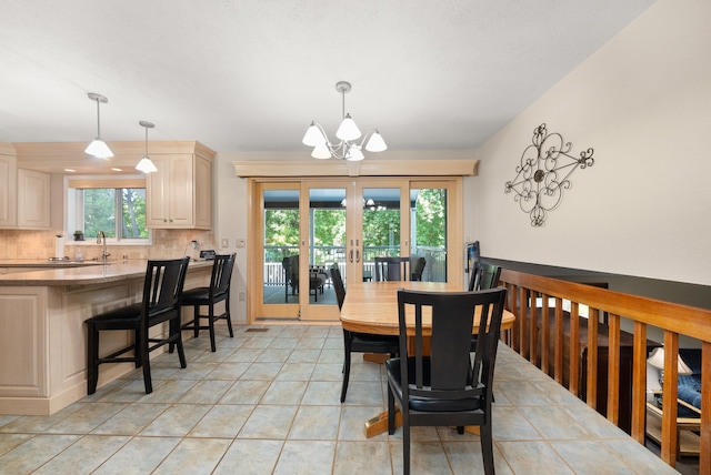 2913 E 61st Ct, Spokane, WA 99223 - dining room featuring a chandelier, french doors, and light tile patterned floors