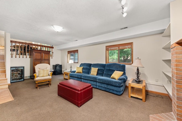 2913 E 61st Ct, Spokane, WA 99223 - living room with beverage cooler, carpet, plenty of natural light, and a textured ceiling