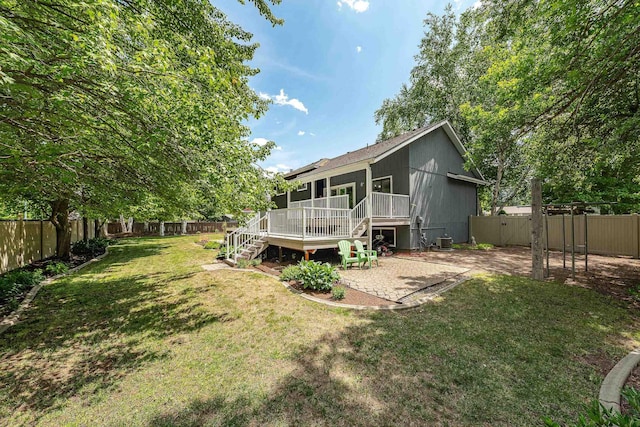 2913 E 61st Ct, Spokane, WA 99223 - back of property featuring a fenced backyard, stairs, a wooden deck, a gate, and a patio area