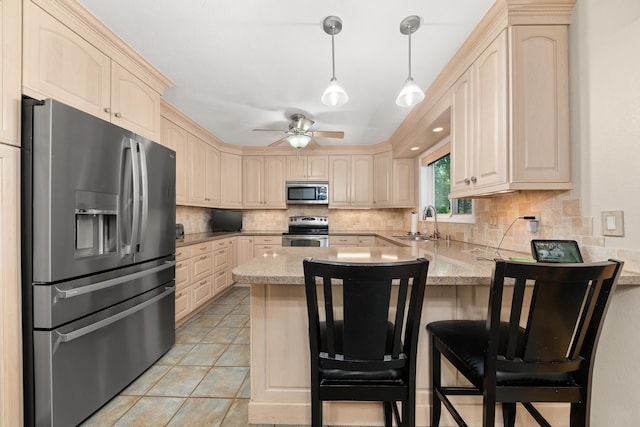 2913 E 61st Ct, Spokane, WA 99223 - kitchen with stainless steel appliances, a peninsula, decorative backsplash, ceiling fan, and light stone countertops
