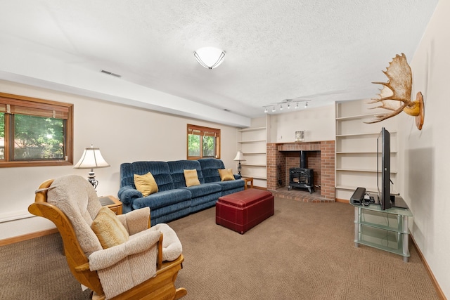 2913 E 61st Ct, Spokane, WA 99223 - living area with a wood stove, carpet floors, and a textured ceiling