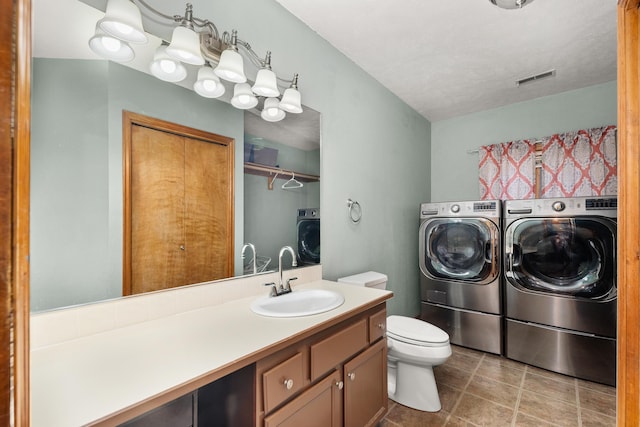 2913 E 61st Ct, Spokane, WA 99223 - full bath with washing machine and clothes dryer, vanity, and a closet