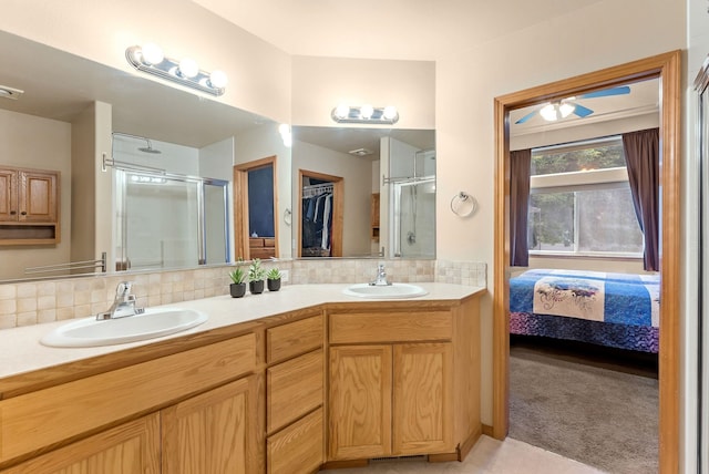 3518 S Woodlawn Dr, Spokane Valley, WA 99206 - bathroom with a shower stall, double vanity, and tasteful backsplash
