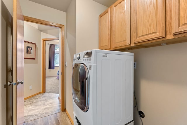 3518 S Woodlawn Dr, Spokane Valley, WA 99206 - washroom with washer / clothes dryer, cabinet space, and light wood-style flooring