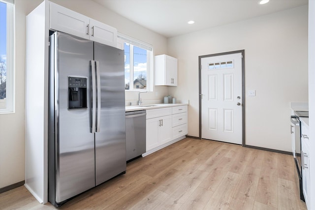 2519 N Columbus Rd, Spokane, WA 99207 - kitchen featuring stainless steel appliances, light wood finished floors, white cabinetry, light countertops, and recessed lighting