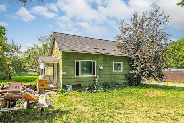 1111 W Main Ave, Chewelah, WA 99109 - rear view of property with roof with shingles and a lawn