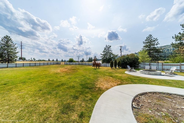 24404 E Roxanne Ave, Newman Lake, WA 99025 - fenced backyard featuring a fire pit and a patio area
