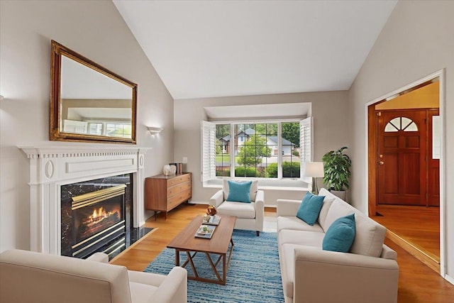 15116 N Edencrest Dr, Spokane, WA 99208 - living area featuring vaulted ceiling, light wood-type flooring, and a fireplace