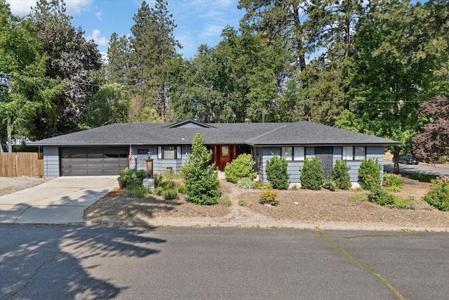 3410 S Napa St, Spokane, WA 99203 - ranch-style home featuring a garage, driveway, and view of scattered trees