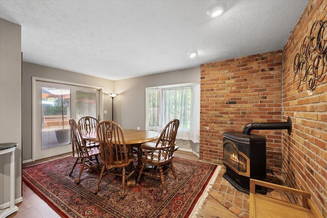 3410 S Napa St, Spokane, WA 99203 - dining area with a wood stove, a textured ceiling, and light wood-type flooring