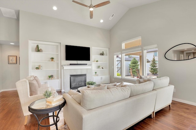 19851 E Kalama Ave, Liberty Lake, WA 99016 - living room with high vaulted ceiling, ceiling fan, a tile fireplace, wood finished floors, and recessed lighting