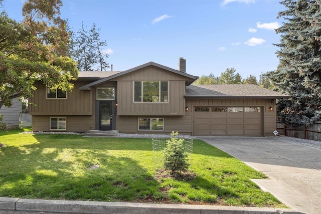 14417 N Dakota Rd, Spokane, WA 99208 - raised ranch featuring a garage, a chimney, and concrete driveway