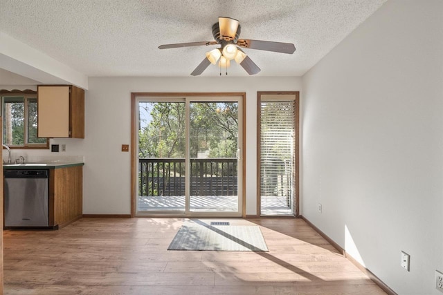14417 N Dakota Rd, Spokane, WA 99208 - doorway to outside with a textured ceiling, light wood-type flooring, and ceiling fan