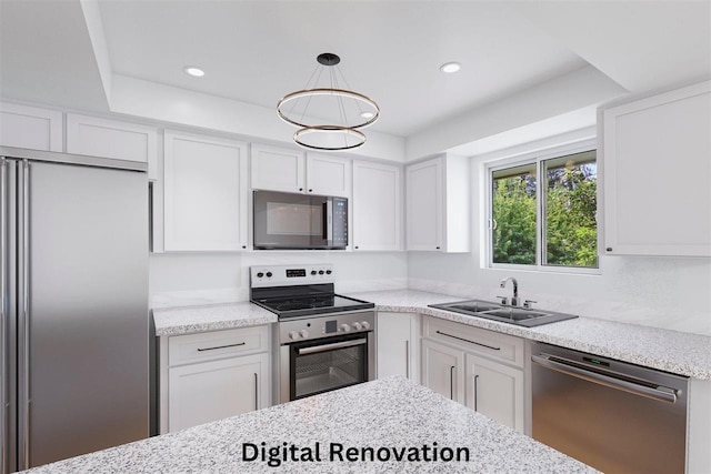 14417 N Dakota Rd, Spokane, WA 99208 - kitchen featuring appliances with stainless steel finishes, white cabinets, recessed lighting, and hanging light fixtures